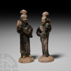 Chinese Ming Female Figure Pair Ming Dynasty, 1368-1644 A.D. A pair of glazed ceramic female figures each standing on a domed base wearing a floor-len...