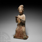 Chinese Tang Terracotta Court Lady Tang Dynasty, 618-907 A.D. A ceramic figure of a lady in floor-length courtly dress with right hand holding a disc ...