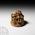 Chinese Han Style Gilt Coiled Lionesque Creature 20th century A.D. or earlier. A Han Dynasty style, sinuous gilt bronze lionesque beast, modelled in a...