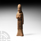 Chinese Tang Attendant Figure Tang Dynasty, 618-907 A.D. A ceramic attendant figure modelled standing and wearing a floor-length hooded garment, styli...