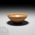 Chinese Glazed Bowl Circa 618-1279 A.D. A Tang or Song period bowl with a carinated body; unglazed. 102 grams, 11 cm diameter (4 1/4 in.). Acquired 19...