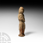 Chinese Tang Warrior Figure Tang Dynasty, 618-907 A.D. A ceramic warrior figure modelled standing, wearing a headdress and chest plate; remains of pig...