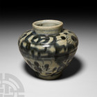Chinese Blue and White Peony Jar 17th-18th century A.D. A glazed Yuan style provincial ceramic jar with broad shoulder and tapering body, applied flor...