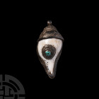 Tibetan Silver Mounted Shell with Turquoise Early 20th century A.D. A conch shell mounted in a silver case decorated with dense panels of mythical cre...