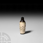 Chinese Snuff Bottle 20th century A.D. A piriform turned bovine bone and horn snuff bottle, displaying an erotic scene set in a landscape and accentua...