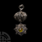 Medieval Jewelled Button 15th-17th century A.D. A squat spherical button decorated with a series of integral vertical flanges, central cell set with a...