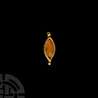 Medieval Gold and Carnelian Eye-Shaped Pendant 8th-12th century A.D. An eye-shaped pendant composed of a slender beaded gold frame, suspension loop ab...