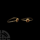 Medieval Gold Ring with Garnet Gemstone 13th-15th century A.D. A gold ring composed of a slender, round-section hoop and oval plaque with tear-shaped ...