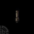 Medieval Head Mount 13th-15th century A.D. A copper-alloy mount composed of a carinated arm and terminal formed as a stylised human head. 27.9 grams, ...