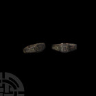 Medieval Ring with Symbols 12th-14th century A.D. A bronze finger ring with butted ends to the hoop, rectangular bezel with addorsed hook motifs, styl...
