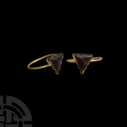 Medieval Gold Ring with Garnet 12th-14th century A.D. A gold ring with slender round-section penannular hoop with bulbous terminals, supporting a tria...