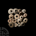 Medieval Spindle Whorl Collection 12th-16th century A.D. A mixed group of lead-alloy spindle whorls of various sizes and forms, including decorated ex...