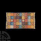 Moroccan Rug 20th century A.D. A hand woven rug with tassels to two edges; decorative scheme composed of square panels bearing various tufted and embr...