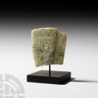 Prehispanic Mayan Jade Head Plaque Circa 8th-12th century A.D. A jade plaque fragment with tapering profile, bearing a carved bearded male face wearin...