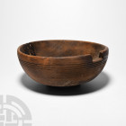 Prehispanic Inca Wooden Bowl Early 16th century A.D. A wooden bowl with D-section wall and shallow foot, decorative circumferential ribs to the upper ...