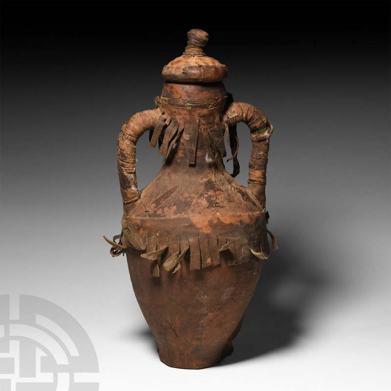 North African Amphora Wrapped in Leather 20th century A.D. A glazed ceramic amph...