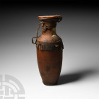 North African Jug Wrapped in Leather 20th century A.D. A glazed ceramic bottle encased in a leather cover with integral hinged discoid lid and braided...