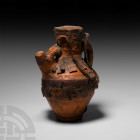 North African Amphora Wrapped in Leather 20th century A.D. A glazed ceramic ewer encased in a leather cover with braided thong handle, fringe to the s...