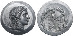 Aeolis, Myrina AR Tetradrachm. Circa 155-145 BC. Stephanophoric type. Laureate head of Apollo to right / Apollo Grynios standing to right, holding phi...