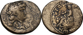 Nero (54 68). AE 19 mm, Anazarbus mint (Cilicia), dated year 86 (67-68 AD). Obv. Laureate head right; c/m, male bust. Rev. Boule seated left, holding ...