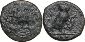 Sicily. Kamarina. AE Tetras, 425-405 BC. Obv. Gorgoneion. Rev. Owl standing right, head facing, wings closed, holding lizard; in exergue, three pellet...