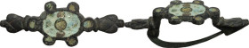 Bronze fibula with glass paste inlaid. Barbaric-roman period. 53 x 23 mm.