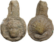 Lead pendant with facing head and cockle shell. 21x13 mm. Greek. 7.13 g.