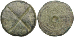 Bronze board game token decorated with a cross and concentric circles. Roman period. Diameter: 17 mm.