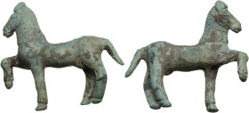 Bronze horse statuette, right foreleg raised. Engraved details and decoration. Roman period. 52-49 mm.