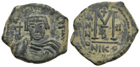 Maurice Tiberius AD 582-602. Nikomedia Follis Æ (28mm, 13.2 g). Helmeted and cuirassed bust facing, holding globus cruciger and shield / Large M; cros...