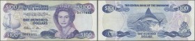 Bahamas: 100 Dollars ND(1984) P. 49, rare note, used with only light folds, a few pinholes, pressed but still with strong paper and nice colors, condi...