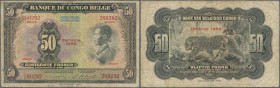 Belgian Congo: 50 Francs 1950 P. 16, used with many folds and creases, stained paper, no holes but minor border tears, condition: VG+ to F-.