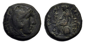 Seleukid Kings. Seleukos II Kallinikos (246-226 BC). Æ (15,4 mm, 4,2 g). Sardes. Head of Herakles r., wearing lion skin.
R/ Apollo seated l. on omphal...
