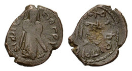 Islamic, Umayyad Caliphate. temp. 'Abd al-Malik ibn Marwan. AH 65-86 / AD 685-705. Æ Fals (18 mm, 3 g). Arab-Byzantine Standing Caliph type. Uncertain...