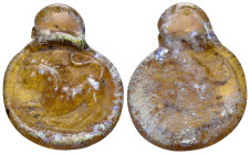 EASTERN MEDITERRANEAN. 4th century. (Glass, 24 mm, 1.79 g). Lion pouncing to left; all in relief on a translucent amber disk with a rolled rim and sus...