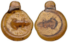 EASTERN MEDITERRANEAN. 4th century. (Glass, 25 mm, 2.10 g). ZO-HN Frog in relief on a translucent amber disk with a rolled rim and suspension loop. Cf...