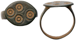 Roman Ring. Bronze Æ (3.4 gr.), 1st - 2nd Century AD. Simple cast ring with central bezel incised with circular design.

Very Fine.