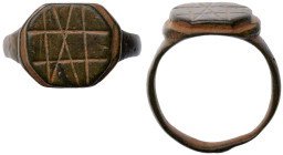 Roman Ring. Bronze Æ (6.5 gr.), 1st - 2nd Century AD. A simple bronze ring with a oval shaped bezel. The face is incised with a cross-section pattern....