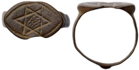 Roman Ring with Blue Stone. Bronze Æ (3.7 gr.), 1st - 2nd Century AD. A ring with slender round-section hoop, flared bezel with raised cell set with a...
