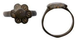 Roman Ring with Floral Design. Bronze Æ (4.2 gr.), 1st - 2nd Century AD. Simple cast ring with floral bezel. Intact.

Very Fine.