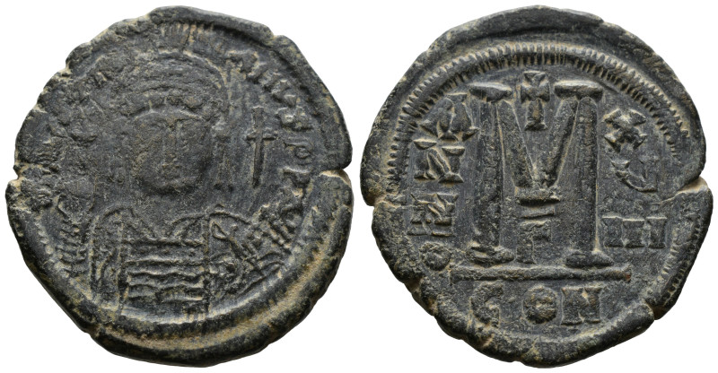 JUSTINIAN I. 527-565 AD. AE Follis Constantinople mint. 
Helmeted, diademed, and...