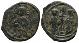 Constantine X, Ducas, with Eudocia. AD 1059-1067. AE Follis (27mm, 10.04g). Constantiople mint. Christ standing facing on low stool, holding Gospels /...