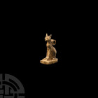 Egyptian Gold Cat Amulet
Third Intermediate Period, 1069-702 B.C. A gold amuletic pendant in the form of a cat sitting on a tongue-shaped base, and a...