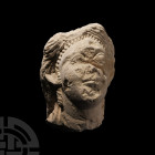 Cypriot Limestone Head
Circa 6th century B.C. A fragmentary limestone female head modelled facing with semi-naturalistic facial features, her hair dr...