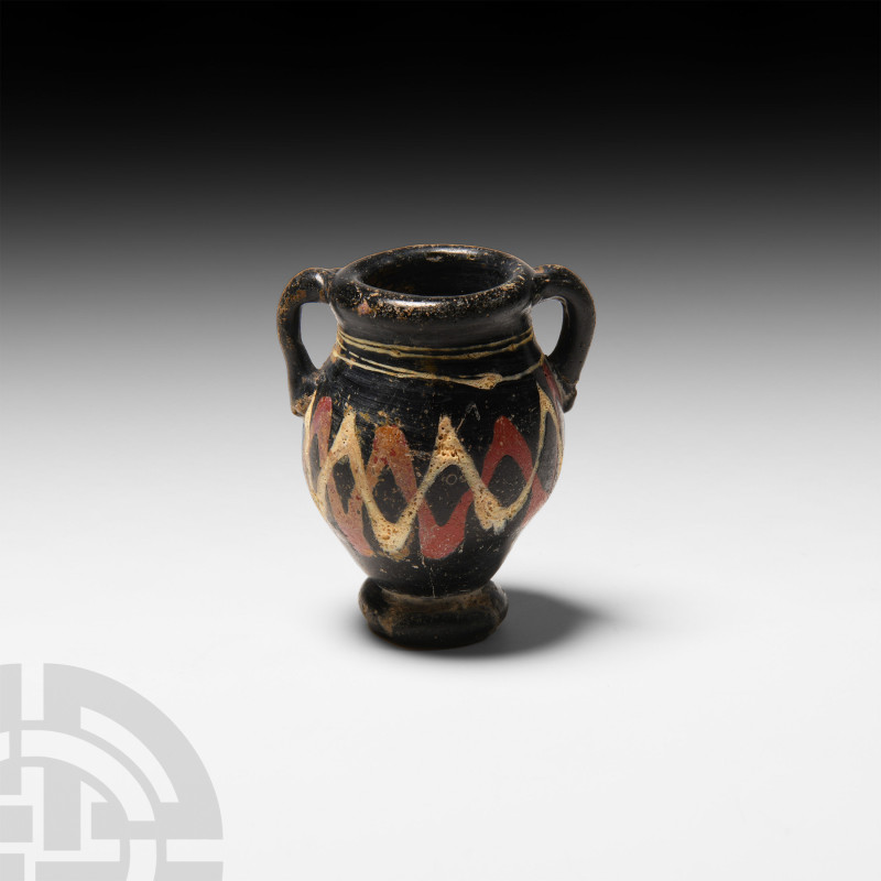 Greek Mosaic Glass Amphora
Circa 3rd century B.C. A miniature glass amphora wit...