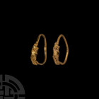 Greek Gold Eros Earrings
3rd-2nd century B.C. A matching pair of gold hoop earrings, each with a nude Eros plaque. Cf. Higgins, R.A., Greek and Roman...