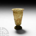 Roman Glass Footed Beaker with Trail
4th-5th century A.D. A green glass beaker composed of a gently tapering U-shaped body with a more convex upper b...