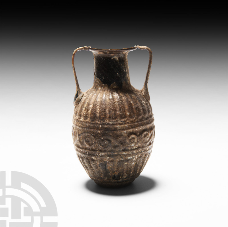 Roman Sidonian Glass Amphoriskos
1st century A.D. A mould-blown glass amphorisk...