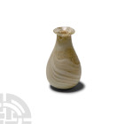 Roman Translucent White Marbled Glass Unguentarium
1st century A.D. A miniature piriform glass bottle with everted rim and opaque white marbling; iri...