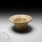 Roman Opaque White Glass Vessel
1st-2nd century A.D. An opaque white glass cup or other vessel with trumpet-style neck and rim, slightly convex body ...